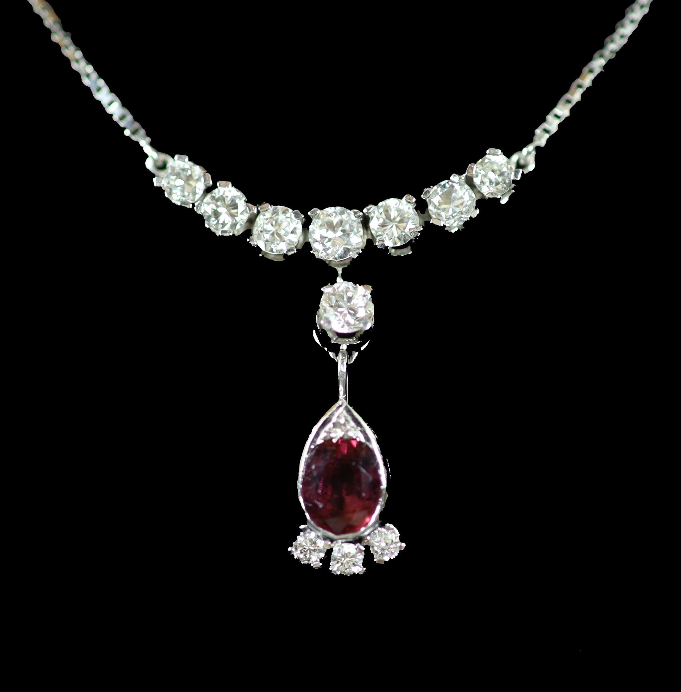 A modern Italian 18ct white gold, single stone oval cut ruby and eleven stone diamond set drop pendant necklace